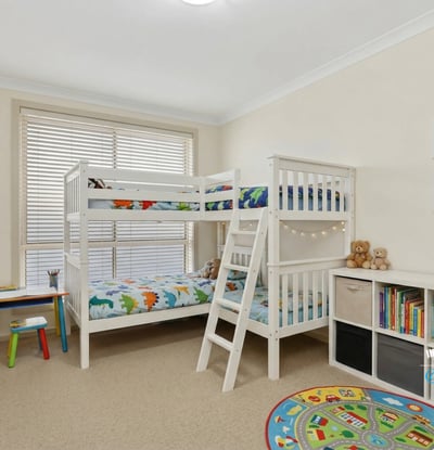 Bright and inviting children's room featuring a bunk bed, playful decor, and ample storage options.