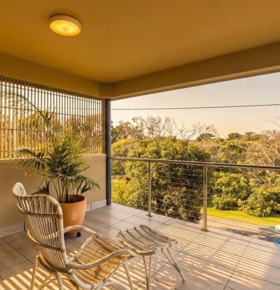 Enjoy morning light and nature views from this inviting balcony, perfect for relaxation or coffee.