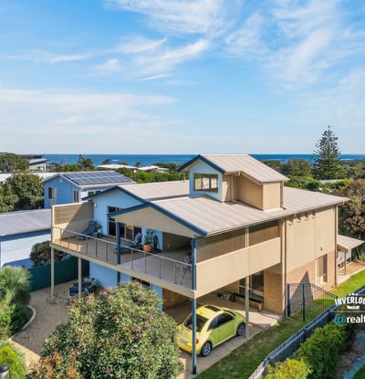 Experience coastal living in this spacious home with stunning ocean views and ample outdoor space.