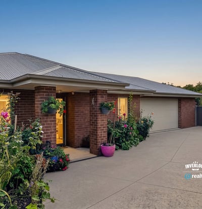 Discover this inviting home featuring lush landscaping and a spacious driveway, ideal for family gatherings.