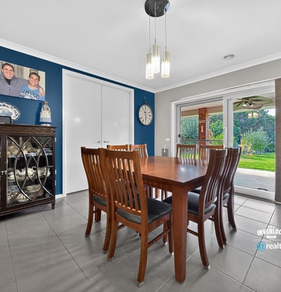 Spacious dining area with direct access to a well-maintained backyard, perfect for gatherings and entertaining.