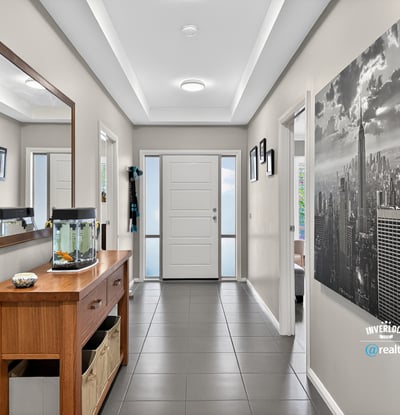 Spacious entryway featuring contemporary decor, natural light, and functional layout for welcoming guests.