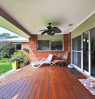 Spacious outdoor deck area perfect for relaxing or entertaining, surrounded by lush greenery and inviting atmosphere.