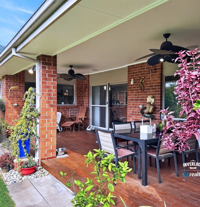 Spacious outdoor patio perfect for entertaining, surrounded by lush landscaping and easy access to indoor living.