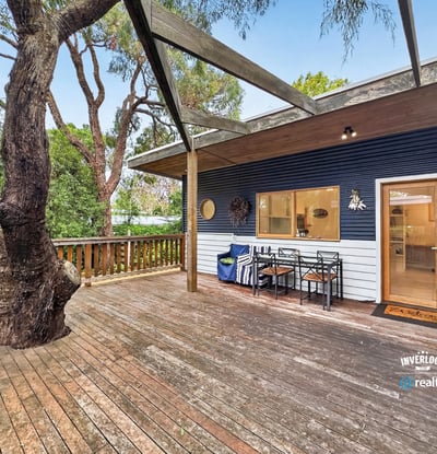 Spacious outdoor deck surrounded by nature, perfect for entertaining or relaxing in a tranquil setting.