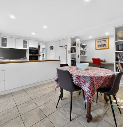 Bright and inviting kitchen and dining area, featuring modern finishes and ample storage space.