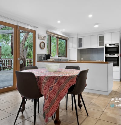 Spacious kitchen with modern appliances and direct access to an outdoor deck, perfect for entertaining.