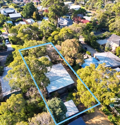Spacious property surrounded by lush greenery, offering ample outdoor space and potential for development.