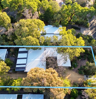 Spacious property surrounded by lush greenery, offering privacy and potential for creative landscaping and development.