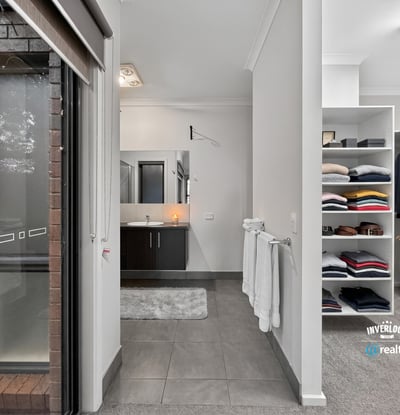 Modern bathroom with a spacious walk-in closet, featuring ample storage for an organized lifestyle.