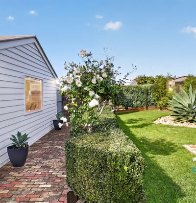 Discover a well-maintained outdoor space featuring lush greenery and a cozy fire pit for gatherings.