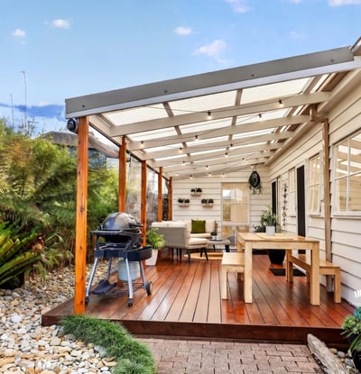 Spacious covered patio with ample seating and outdoor grilling area, perfect for entertaining and relaxing.