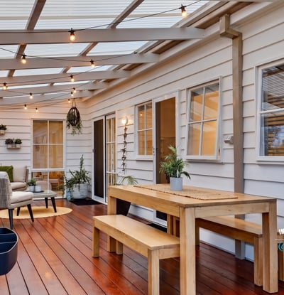Bright, inviting outdoor space features a dining area and seating, perfect for entertaining year-round.