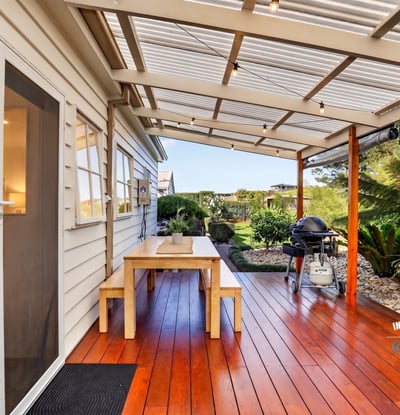 Enjoy outdoor living on this spacious deck, surrounded by lush greenery and perfect for entertaining.