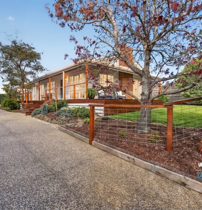 This welcoming home features spacious outdoor areas and a scenic driveway, perfect for family gatherings and relaxation.