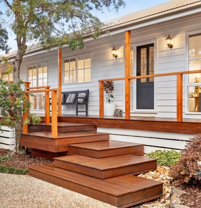 Experience modern living in this inviting home featuring a spacious deck, lush landscaping, and abundant natural light.