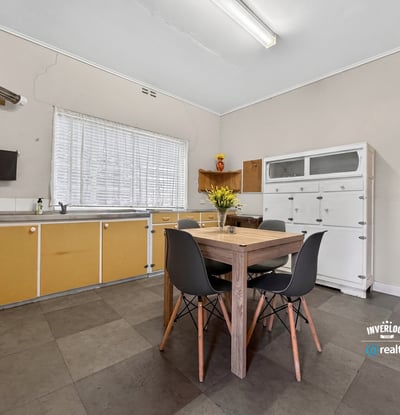 Bright, functional kitchen featuring ample storage and a cozy dining area, perfect for everyday meals.