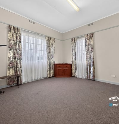 Spacious room featuring large windows, abundant natural light, and versatile flooring for various designs.