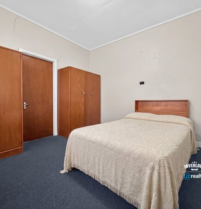 Spacious bedroom featuring a queen-size bed and built-in wardrobes, perfect for personalizing your space.