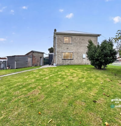Spacious lot features a two-story home and versatile outbuilding, perfect for renovation or investment opportunities.