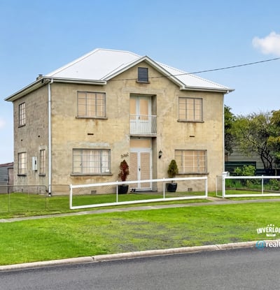 Spacious two-story home featuring ample yard space and unique architectural details in a quiet neighborhood.
