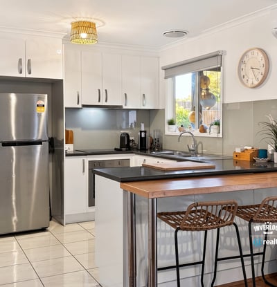 Modern kitchen featuring sleek cabinetry, stainless steel appliances, and a spacious breakfast bar perfect for entertaining.