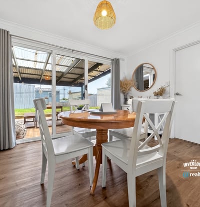 Bright dining area with outdoor access, perfect for enjoying meals and entertaining in a spacious layout.