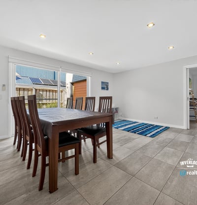 Spacious dining area with abundant natural light, featuring a versatile layout and easy access to outdoor spaces.