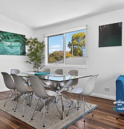 Bright dining area features modern furnishings, large windows, and a contemporary touch, perfect for gatherings.