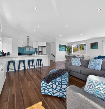 Modern open-concept living space with abundant natural light, featuring a sleek kitchen and inviting lounge area.
