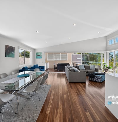 Spacious open-plan living area with abundant natural light, modern furnishings, and picturesque views.