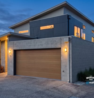 Modern two-story home featuring large windows, contemporary design, and convenient garage access in a vibrant neighborhood.