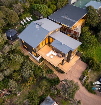 Spacious contemporary home nestled in nature, featuring expansive outdoor living areas and stunning views.