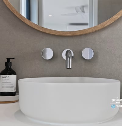 Sleek modern sink with a circular design, complemented by contemporary fixtures and minimalist decor.