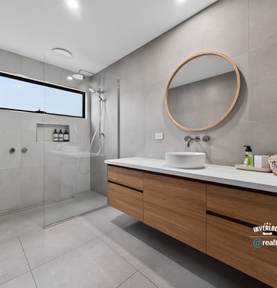 This modern bathroom features a spacious design, sleek finishes, and natural light from a large window.