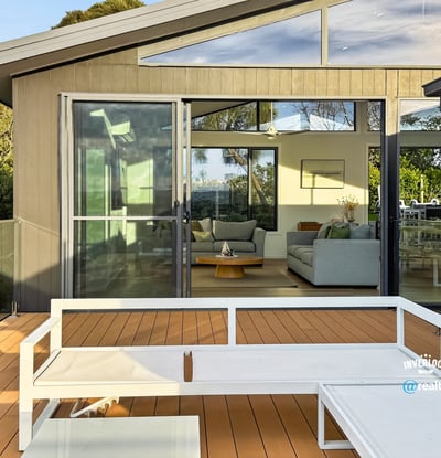 Modern home featuring a spacious deck with expansive views, seamlessly connecting indoor and outdoor living areas.