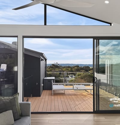 Bright and airy living space opens to a spacious deck, offering stunning views of the landscape.