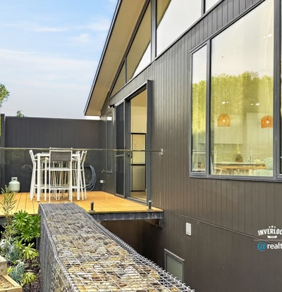 Modern home featuring an expansive deck, perfect for outdoor dining and enjoying scenic views.