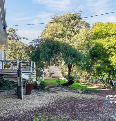 This property features a spacious outdoor area, perfect for relaxation and entertaining amidst lush greenery.