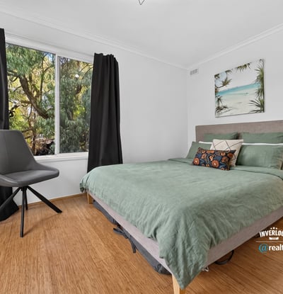 Bright bedroom featuring large window with natural light, contemporary furnishings, and a relaxed, inviting atmosphere.
