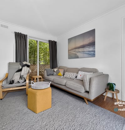 Bright and inviting living space featuring large windows, modern furnishings, and a seamless connection to outdoor views.