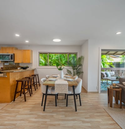 Modern open-concept kitchen and dining area, seamlessly connecting to a bright outdoor living space.