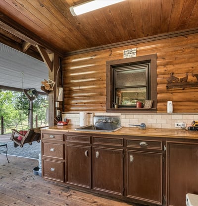 Enjoy rustic charm in this inviting kitchen space, perfect for entertaining on the covered patio.