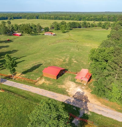 Spacious rural property featuring open fields, multiple outbuildings, and scenic views, perfect for your dream home.