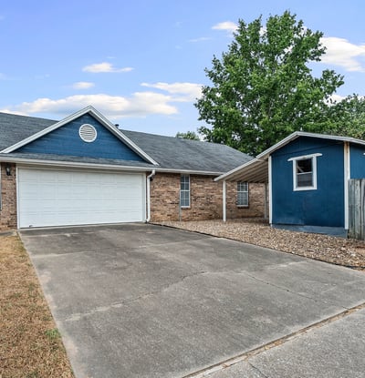 Two car garage on the side and one car carport attached to the shed