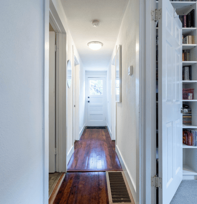 Bright and welcoming corridor featuring a mix of natural light and functional design elements.