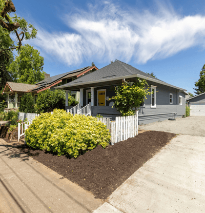 Inviting home featuring updated landscaping, ample parking, and a spacious yard for outdoor activities.