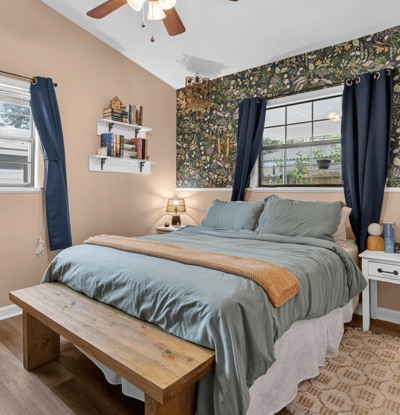 Cozy primary bedroom with ample natural light, perfect for relaxation.