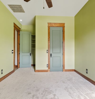 Well-proportioned bedroom with custom trim details, neutral tones, and inviting natural light. Ideal for flexible living arrangements or guest accommodations.