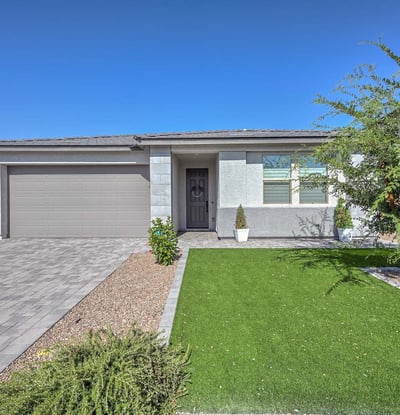 Crisp lines, designer stone accents, and easy-care desert landscaping define this newer construction Peoria home s refined curb appeal.